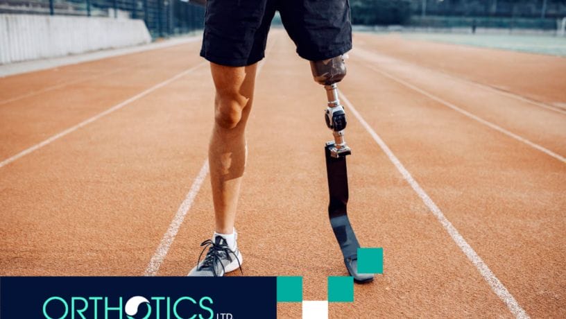 An athletic amputee wearing prosthetic standing in a track field