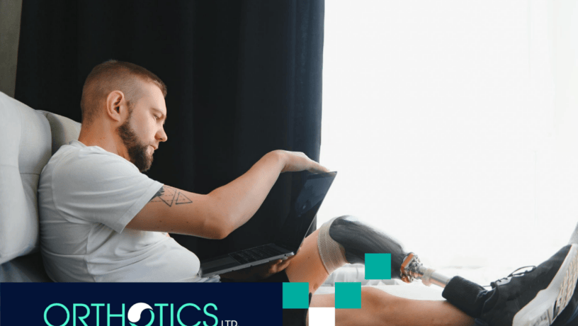 A man wearing prosthetics sitting on a couch