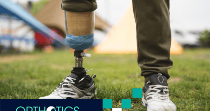 An amputee wearing a prosthetic leg standing on the grass