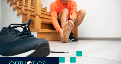 A man is holding his hurting foot