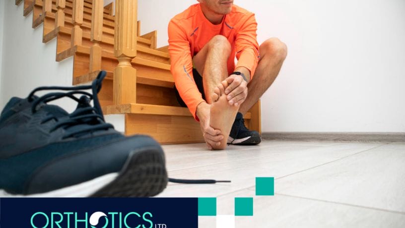 A man is holding his hurting foot