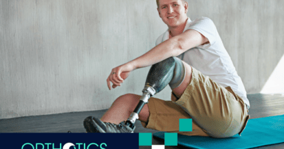 An amputee wearing prosthetics sitting on a mat
