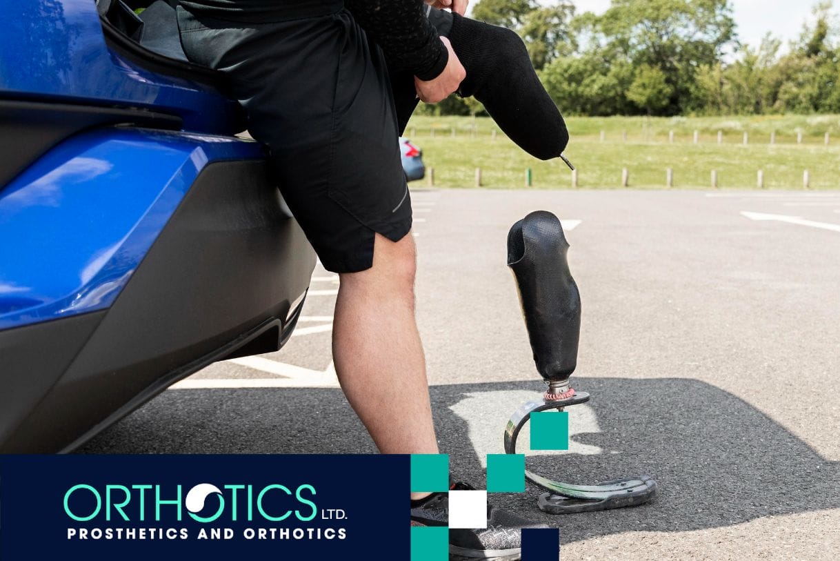 An amputee standing outdoors with his prosthetics